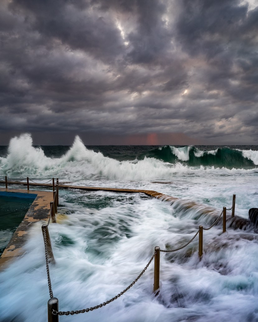 Large swell waves arriving on a coastline during a sunny day with