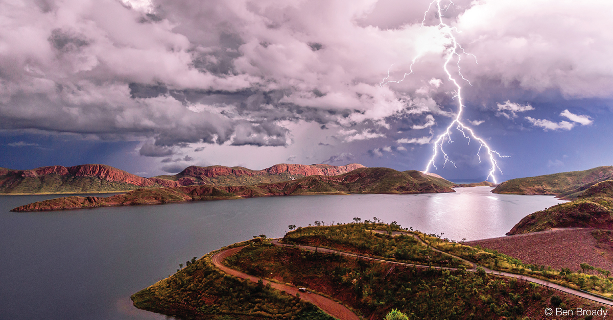 Lightning strike from a cloudy sky over a lake