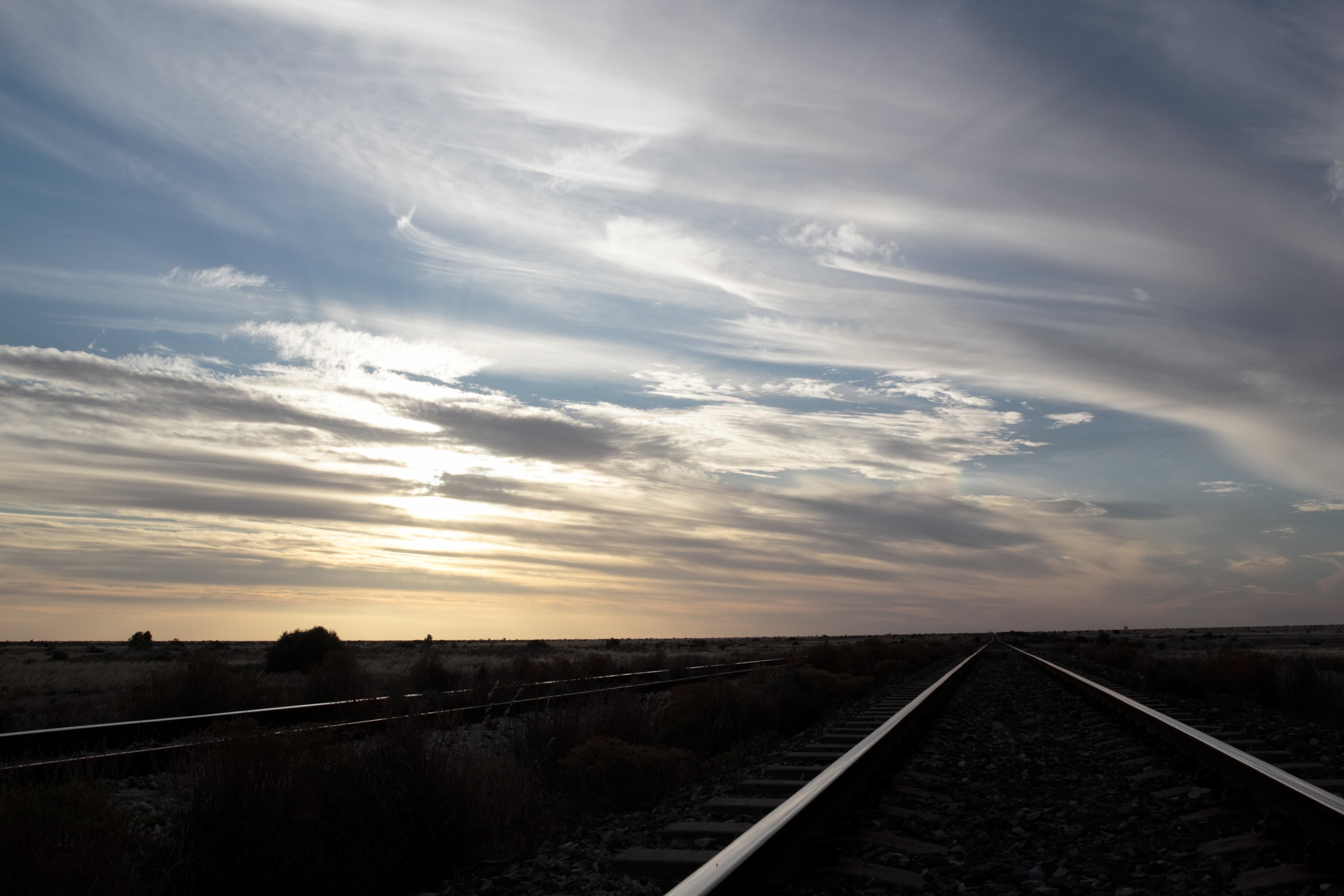 Sky full of smooth cloud over railway lines