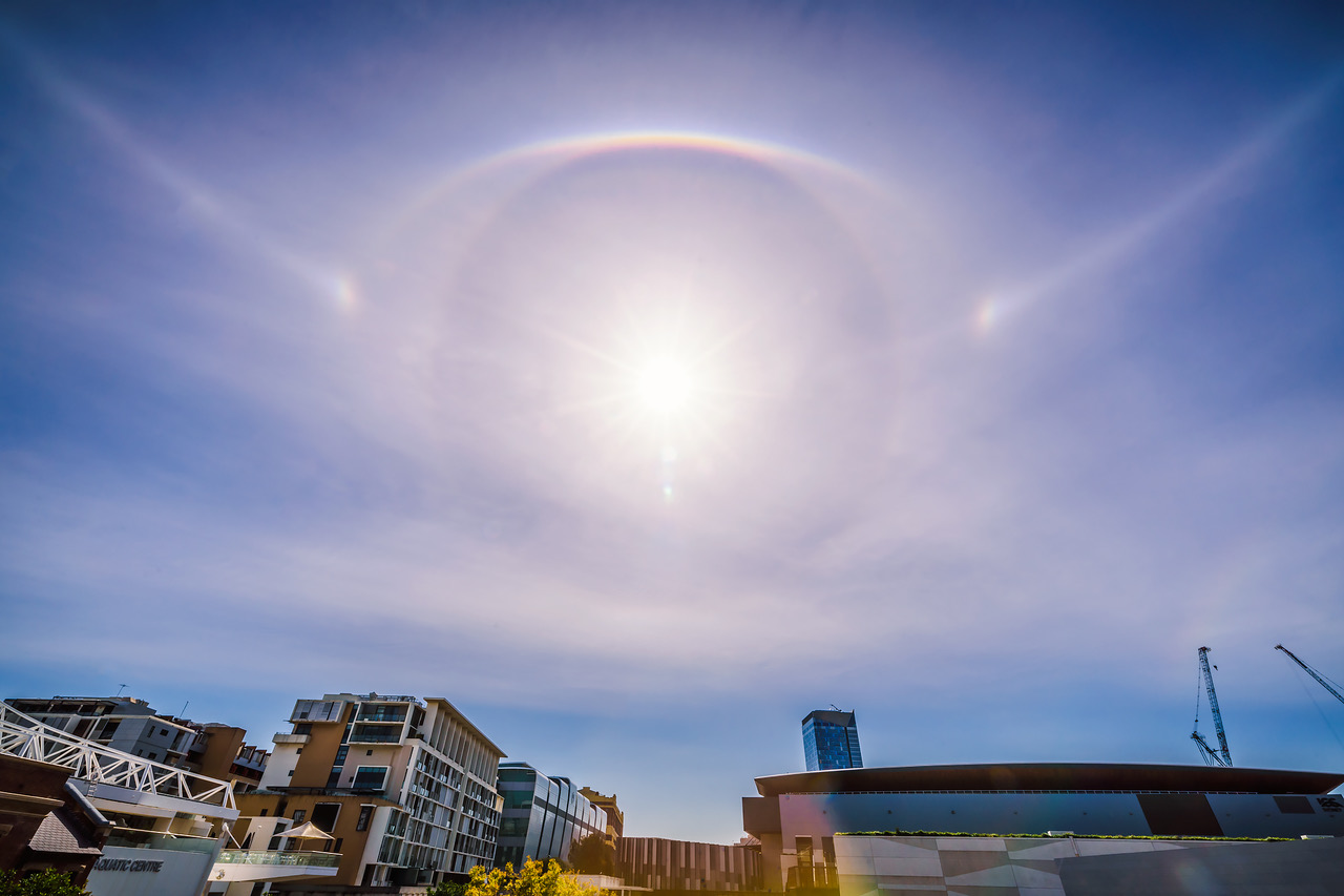 Parhelic circle, 22° halo, sun dogs and upper tangent arc in sky over buildings in Manly, Sydney